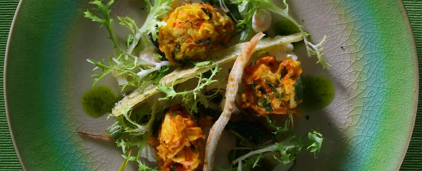 Vegan dish with dressing on a green plate by PenniBlack.