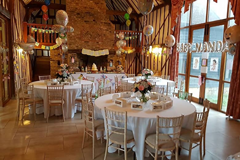Baby shower setup with tables, balloons and more.