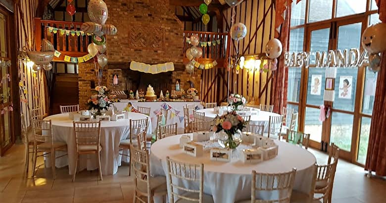 Baby shower setup with tables, balloons and more.