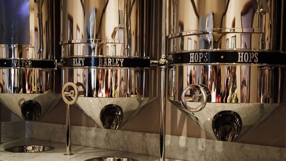 Three shiny brewery tanks.