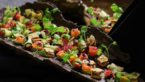 A selection of canapés presented on specially cleaned and treated bark platters.