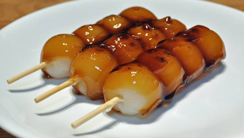 A plate with three skewers of Dango.