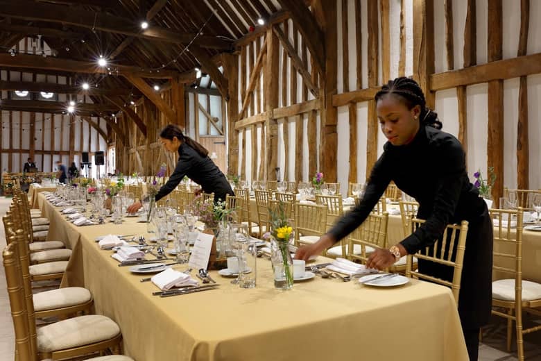 PenniBlack team setting up tables for an event.