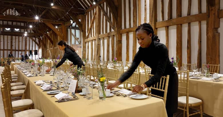 PenniBlack team setting up tables for an event.
