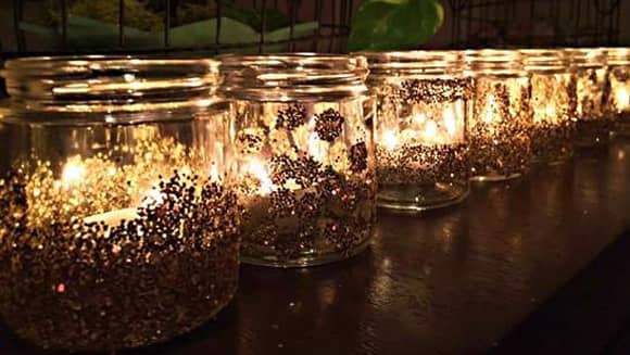 A row of glowing glitter jars.