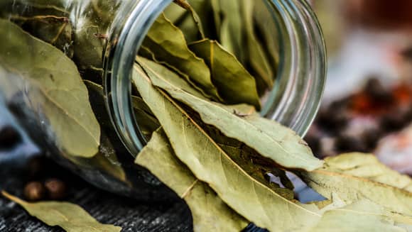 Open jar of bay leaves.