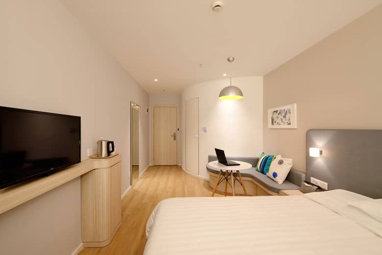 A modern guest bedroom in a hotel.