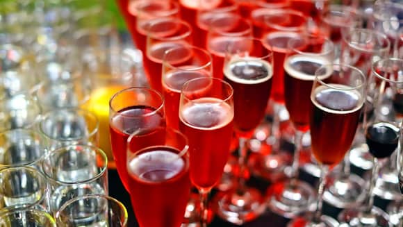 Glasses of Kir Royale and red raspberry vodka.
