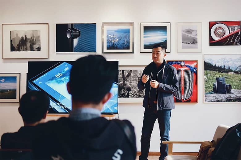 Man presenting to a room of colleagues.
