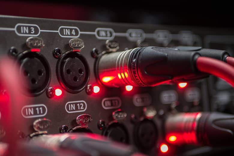 A microphone cable mixer with input plugs.