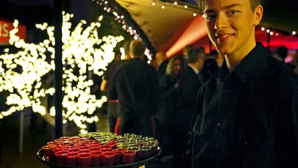 PenniBlack barman with a tray of shots.