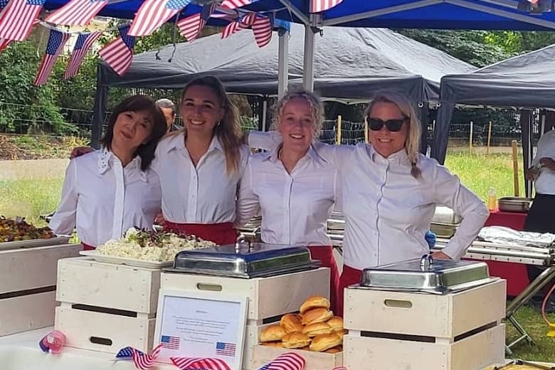 Smiling PenniBlack events team catering for a summer event.