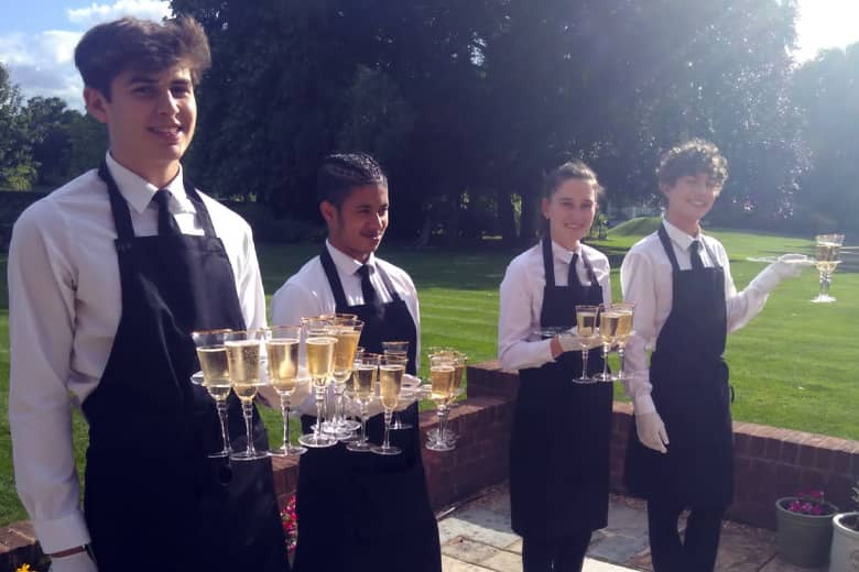 PenniBlack team serving champagne in the sunshine.