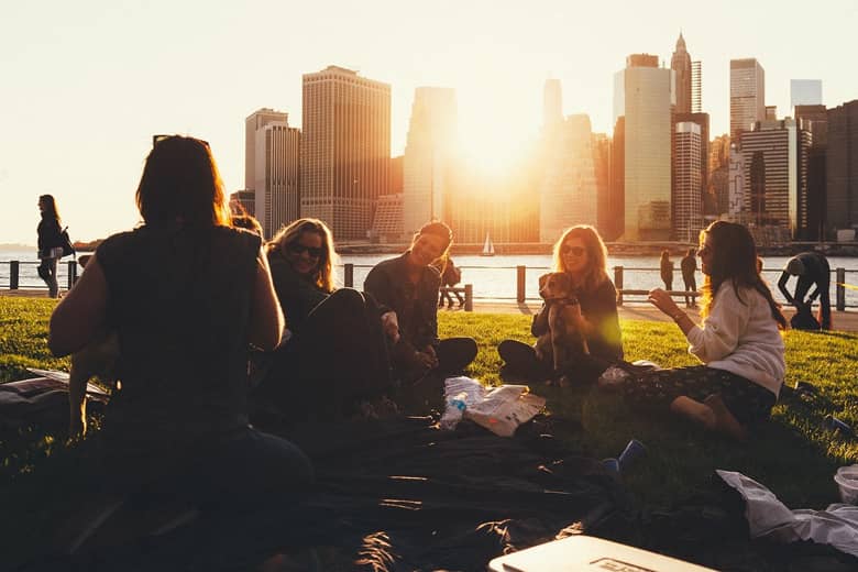 Friends having a summer picnic by the river.