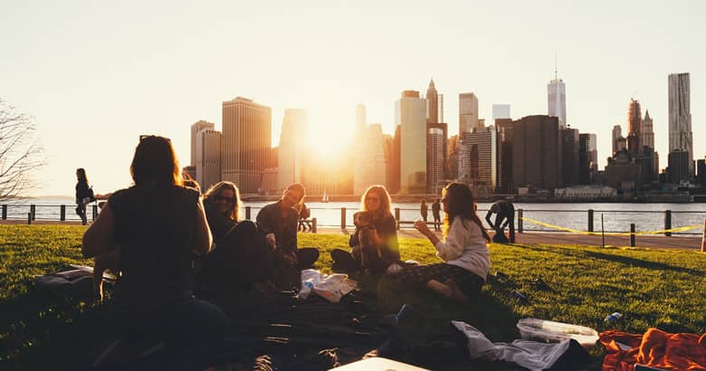 Friends having a summer picnic by the river.