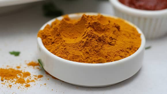 A bowl of ground Turmeric spice.