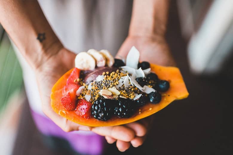 Fresh fruit dish cupped in hands.