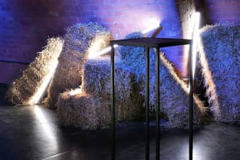 Dramatic lighting with hay bales and poser table.