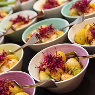 Seared scallops, minted pea puree, new potato, crispy bacon, and a rich port glaze bowls.