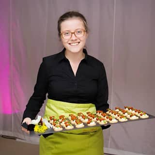 PenniBlack waitress with a slate tray of canapés ready to serve.