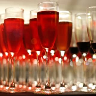 Glasses of Kir Royale and vibrant red raspberry vodka.