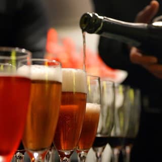 PenniBlack bartender pouring arrival drinks.