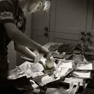 Chef preparing bark platters for service.