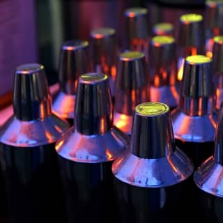 Cocktail shakers lined up at the bar.