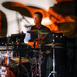 The band drummer during a live performance.