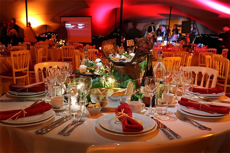 Ferblanc Ball event tables with band in the background.