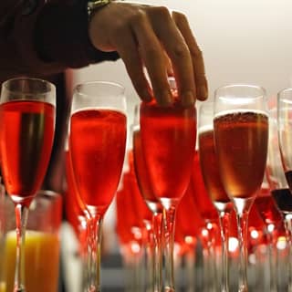 A guest selecting a glass of Kir Royale from the drinks collection.