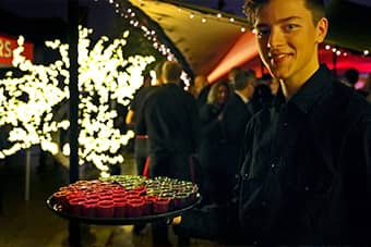 PenniBlack waiter with a tray of shot glasses.