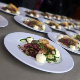 Plates of beetroot carpaccio starters ready for service.