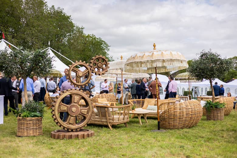 Outdoor space setup with bamboo sofas and wicker chairs were arranged into informal lounge areas beneath parasols.