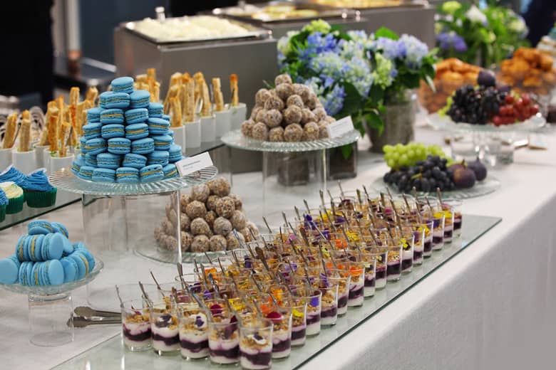 Breakfast buffet including yogurt with blueberry compote and coconut flapjack power balls.