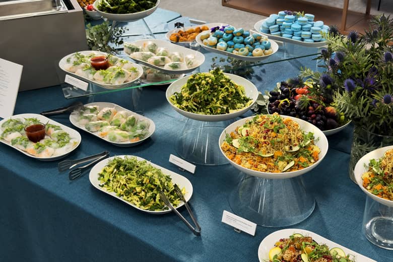 Buffet lunch spread including heritage carrot couscous, and red cabbage salad.