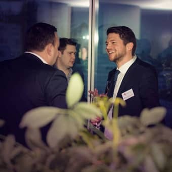 Two guests at the Strawberry Star Office Launch smiling and talking.