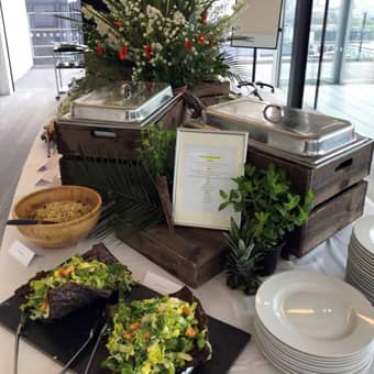 Hot buffet serving dishes with natural wood and floral decorations.