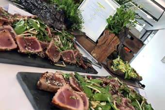 Themed buffet table with seared sesame tuna on slates.