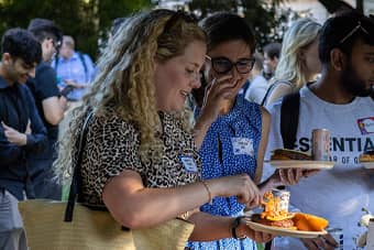 Guests talking and serving food.