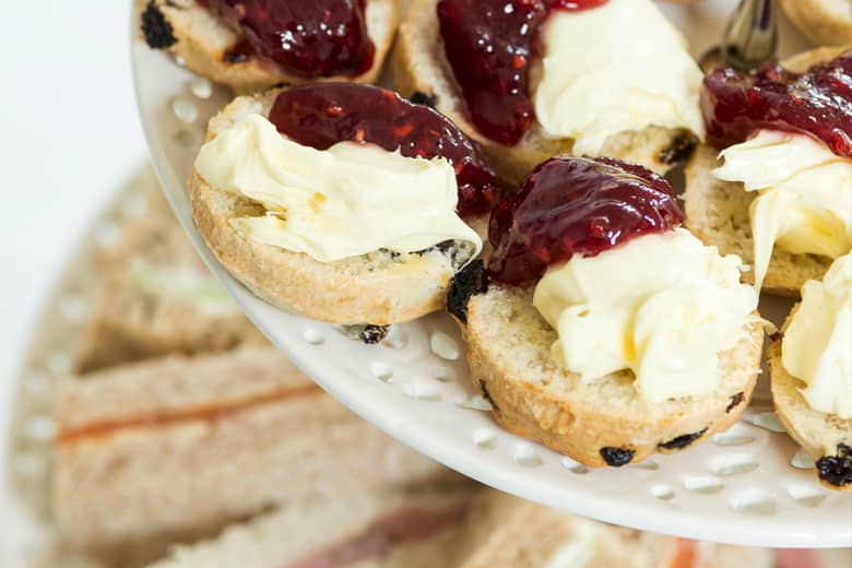 Afternoon tea tier stand with scones and finger sadwiches.