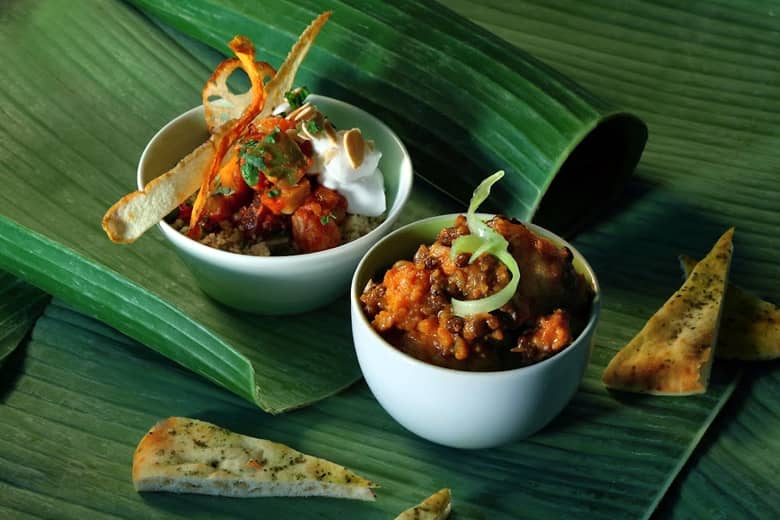 Vegan bowls served on palm leaves.