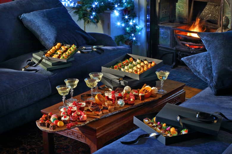Christmas canapés served in PenniBlack Boxes with bubbles and fireplace.