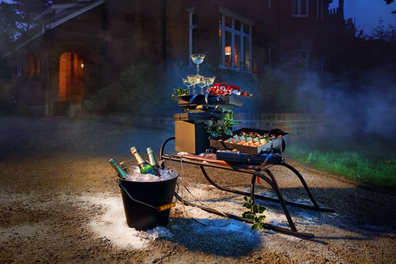 Christmas sleigh delivery of canapés with champagne on ice.