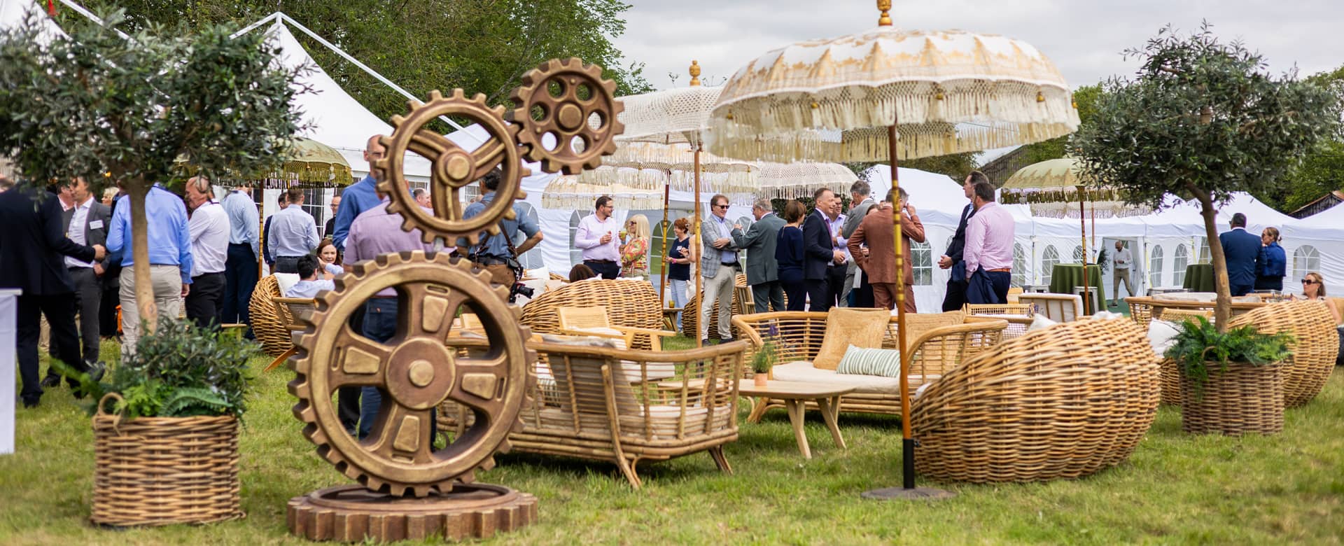 Outdoor space setup with bamboo sofas and wicker chairs were arranged into informal lounge areas beneath parasols.