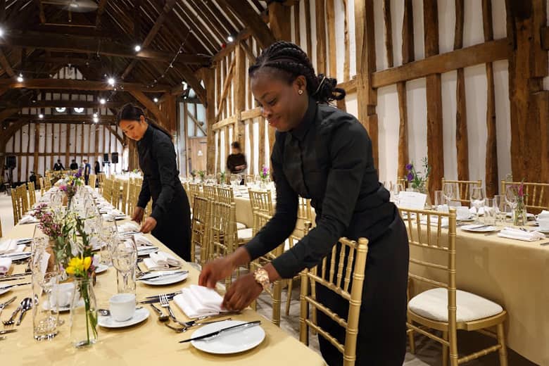 Two of the PenniBlack team setting dining places.