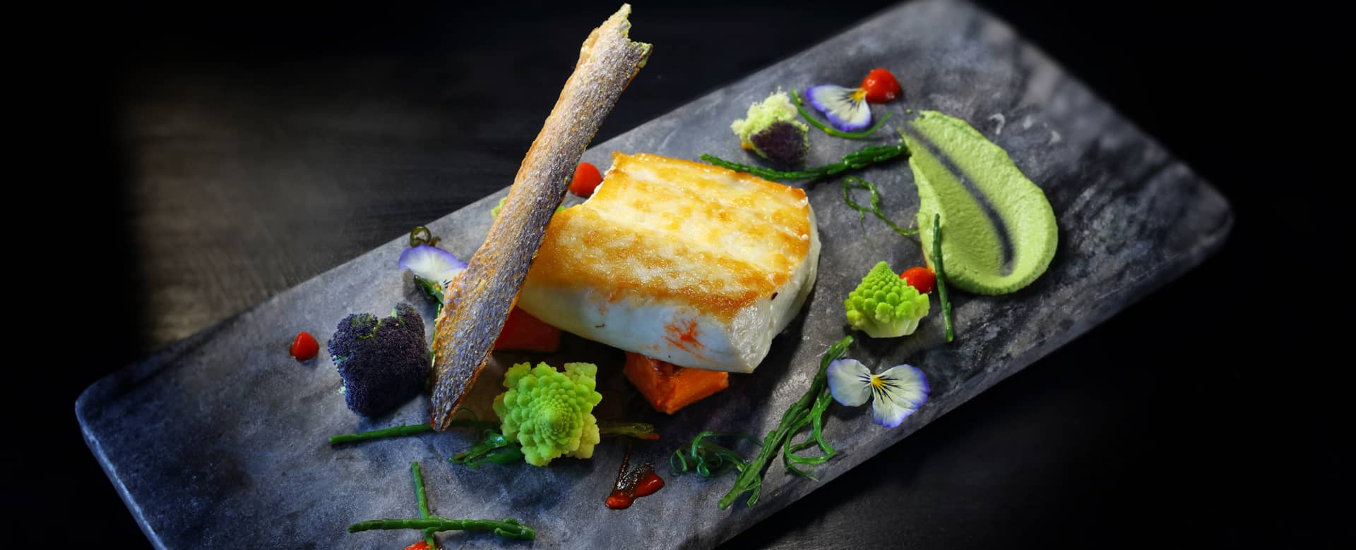 Seared halibut with pea purée, crispy skin wafer, tom berries.