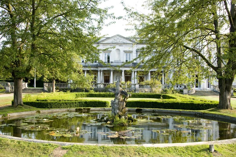 Grove House exterior with gardens and fountain.