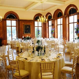 Dining arrangement in the Portrait Room with floral decorations and tableware.