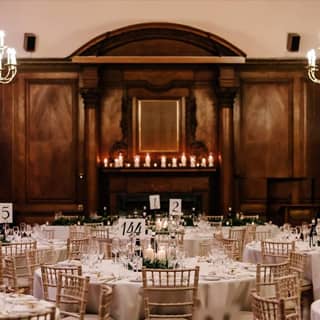 Gala dinner setup in the Portrait Room with candles along the fireplace.